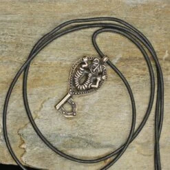 Viking Gripping Bear Key Pendant -The Viking Dragon Shop ad bronze gripping beast key pendant on rock with thong