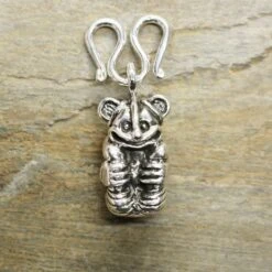 Gripping Bear Pendant -The Viking Dragon Shop ad silver gripping bear pendant on butterfly clasp on rock