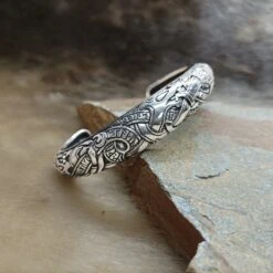 Silver Runic Viking Bracelet / Arm Ring -The Viking Dragon Shop ad silver runic arm ring on rock front angle view