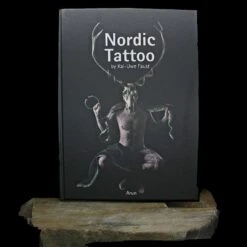 Nordic Tattoo Book - Hardcover - 5th Edition By Kai Uwe Faust -The Viking Dragon Shop bk nordic tattoo book front on rock