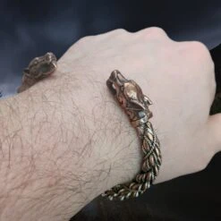 Handmade Twisted Bronze And Silver Arm Ring / Bracelet With Ferocious Wolf Heads -The Viking Dragon Shop bt bronze and silver handmade twisted viking bracelet with ferocious wolf heads on wrist