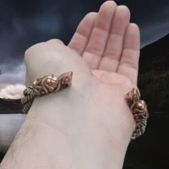 Handmade Twisted Bronze And Silver Arm Ring / Bracelet With Gotlandic Dragon Heads -The Viking Dragon Shop bt bronze and silver handmade twisted viking bracelet with gotland dragon heads on back of wrist