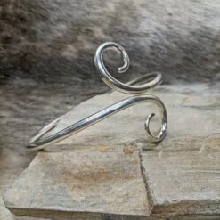 Hand Forged Silver Viking Arm Ring / Arm Band -The Viking Dragon Shop bt silver hand forged twisted viking arm ring on rock angle view