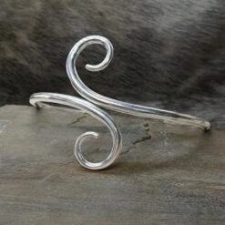Hand Forged Silver Viking Arm Ring / Arm Band -The Viking Dragon Shop bt silver hand forged twisted viking arm ring on rock front view