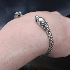 Twisted Silver Viking Bracelet With Ferocious Wolf Heads 9 Twisted Silver Viking Bracelet With Ferocious Wolf Heads -The Viking Dragon Shop bt silver twisted bracelet ferocious wolf heads on wrist angle view