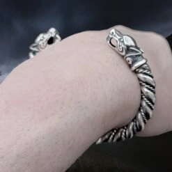 Thick Twisted Silver Viking Bracelet / Arm Ring With Ferocious Wolf Heads -The Viking Dragon Shop bt silver twisted thick arm ring ferocious wolf heads on wrist closer angle view
