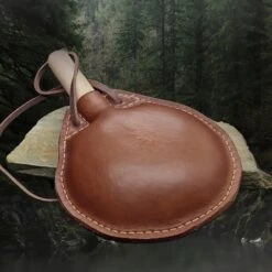 Large Handmade Leather Water Bottle -The Viking Dragon Shop lo large leather water bottle round shapr on rock