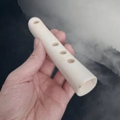 Handy Sized Bone Flute -The Viking Dragon Shop mp bone viking age replica flute in hand angle view