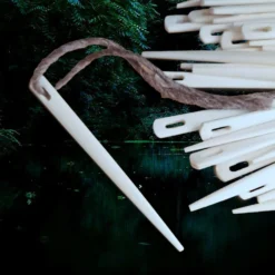 Bone Nalbinding Needle -The Viking Dragon Shop nc bone nalbinding needle with wool yarn and pile of other needles