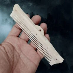 Long Decorated Bone Viking Comb With Hanger -The Viking Dragon Shop nc long bone comb with rivets in hand side angle view