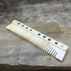 Medium Decorated Bone Viking Comb -The Viking Dragon Shop pm medium bone comb on rock angled view
