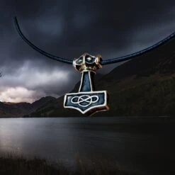 Small Bronze Thunder Thors Hammer Pendant -The Viking Dragon Shop sn bronze small thunder hammer viking pendant on leather thong angle view