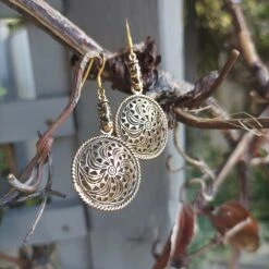 Bronze Gotland Sun Wheel Earrings -The Viking Dragon Shop sn bronze sunwheel earrings with dragon heads hanging in tree