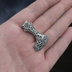 Silver Bearded Axe Head Pendant -The Viking Dragon Shop sn silver bearded axe head pendant on hand slight angle view