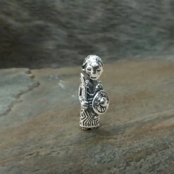 Small Silver Valkyrie Pendant 6 Small Silver Valkyrie Pendant -The Viking Dragon Shop sn silver small valkyrie pendant on rock front view