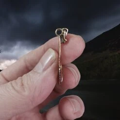 Oseberg Bronze Viking Ship Pendant -The Viking Dragon Shop wl bronze oseberg viking ship pendant in fingers side view