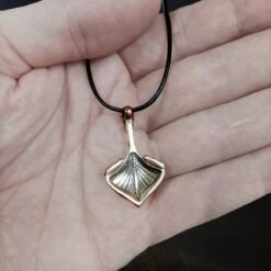 Oseberg Bronze Viking Ship Pendant -The Viking Dragon Shop wl bronze oseberg viking ship pendant on leather thong on hand back view