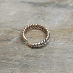 Bronze Braided Viking Ring -The Viking Dragon Shop wl twisted bronze viking ring on rock back view